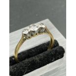 An 18ct yellow gold set three stone diamond ring. (Approximate weight 2.5g) Size P