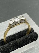 An 18ct yellow gold set three stone diamond ring. (Approximate weight 2.5g) Size P