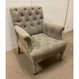 A contemporary French style button back arm chair with hessian detail to back and sides