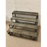 A four tier wrought iron plant stand
