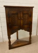 A gothic oak shelved corner cabinet Height 98cm Width 65cm Depth 36cm