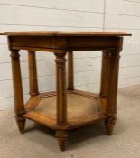 A hexagonal oak glass topped side table with wicker to base Height 55cm 55cm across