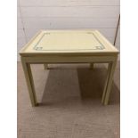 A light green painted side table with gold piping and blue geometric details (H51cm W66cm D66cm)