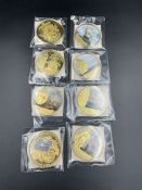 A selection of collectable photo coins, various themes.