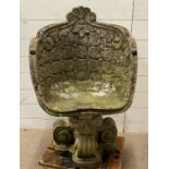 A weathered garden stone chair, tub style with a button back design and scrolling base (H90cm