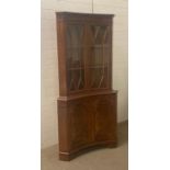 A mahogany glazed corner cabinet with cupboard under (H180cm W80cm)