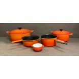 A selection of Le Creuset cookware to include two casseroles dishes, two saucepans and a ramakin