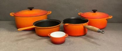 A selection of Le Creuset cookware to include two casseroles dishes, two saucepans and a ramakin