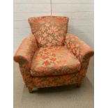 A Marks and Spencer arm chair with orange floral upholstery