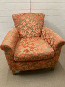 A Marks and Spencer arm chair with orange floral upholstery