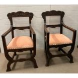 A pair of Victorian carved oak armchair in the 17th century Italian style curule style supports