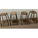 Four industrial style stools, tubular frames and wooden seats