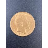 A 1908 gold half sovereign coin.