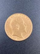A 1908 gold half sovereign coin.
