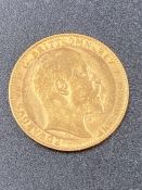 A 1908 gold sovereign coin.