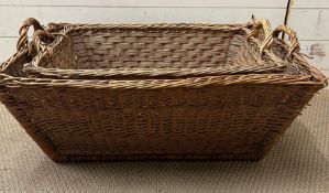 Two wicker handled laundry or log baskets