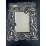 A Japanese antique dragon themed picture frame in white metal (24.5cm x 18.5cm)