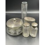 A selection of hallmarked silver topped glass dressing table jars