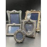 A selection of five silver photo frames, various designs, hallmarks and makers.