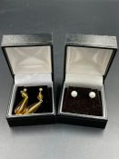 A pair of 9ct gold and amber earrings along with a pair of 9ct gold pearl earrings