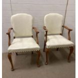 A pair of white leather upholstered carvers on cabriole legs