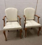 A pair of white leather upholstered carvers on cabriole legs