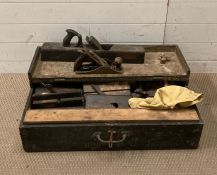 A large wooden tool box containing a selection of vintage tools