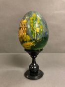 A hand painted egg with a Russian theme