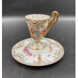A hand painted German Demitasse cup and saucer