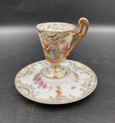 A hand painted German Demitasse cup and saucer