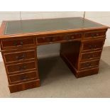 A reproduction green leather topped pedestal desk length 140cm depth 77cm height 80cm