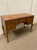 A burr walnut desk with a leather top on cabriole legs (H 77cm x D 49cm x W114cm)