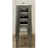 Four brushed steel, Tolix style industrial stools (H76cm)