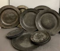 A selection of pewter plates, platters and chargers various ages