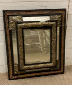 A rectangular mirror with ebonised wood and brass rejected