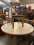 A painted pine pedestal table with five chairs