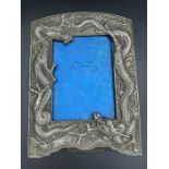 A Japanese antique dragon themed picture frame in white metal (23cm x 16.5cm)