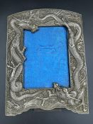 A Japanese antique dragon themed picture frame in white metal (23cm x 16.5cm)