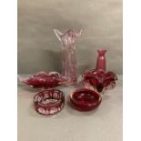 A selection of cranberry glassware to include an ash tray, bowls and a vase