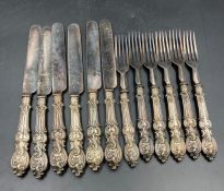 A set of six silver handled knives and forks.AF