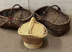 Two wicker handled garden baskets and a small wicker handled lidded picnic basket