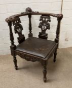 A mid 19th Century Italian corner chair with hand carved arms ending in lion heads