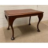 A mahogany side table on cabriole legs with pad feet