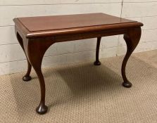 A mahogany side table on cabriole legs with pad feet