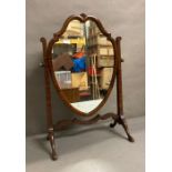 A mahogony framed toilet mirror on splayed legs