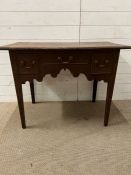 A side table with three drawers on tapering legs (H70cm W94cm D52cm)