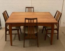 A Mid Century teak extending dining table and four chairs