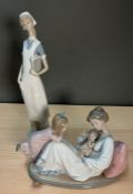 Two Lladro figurines of a nurse and a mother with child