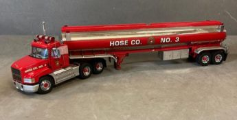 A Franklin Mint Diecast model of a Mack Tractor and Hose Co Trailer