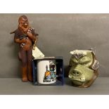 A selection of Star Wars collectables to include A Boba Fett mug, a Wookie and a Gamorrean Guard